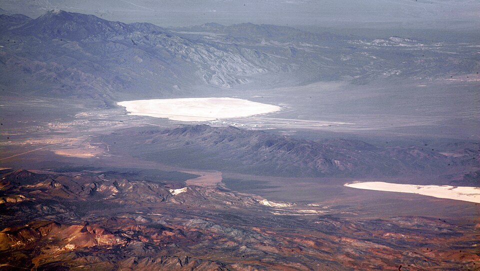 Groom Lake and Papoose Lake, both in the Nevada Test and Training Range. Groom Lake is also in Area 51. Note that some of the lines you see beside Groom lake are among the longest runways on Earth.