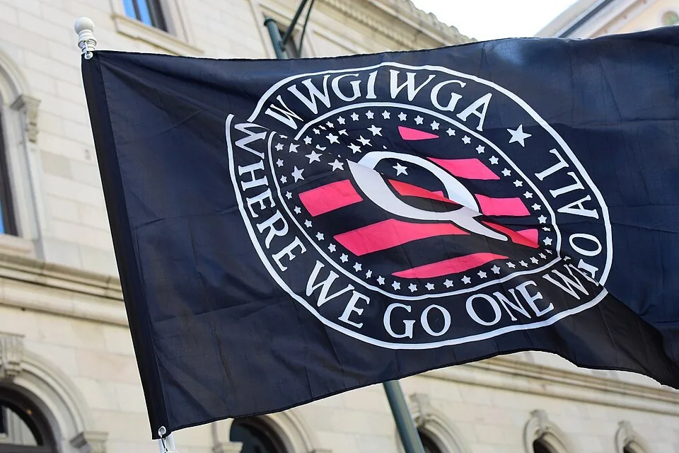 QAnon flag at 2020 VCDL Lobby Day, Richmond, Virginia.
The text around the logo reads: WWG1WGA - Where We Go One We Go All