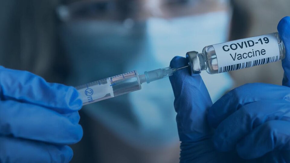 COVID-19 vaccine vial and syringe — contextual photograph